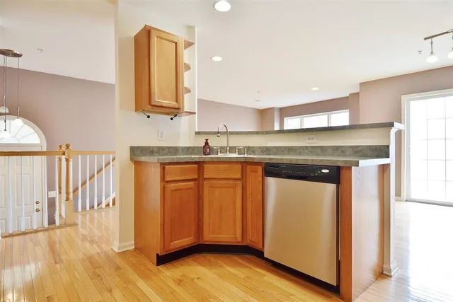 a kitchen with granite countertop wooden cabinets and a sink