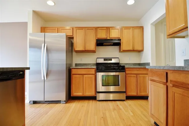 a kitchen with stainless steel appliances a refrigerator sink and microwave
