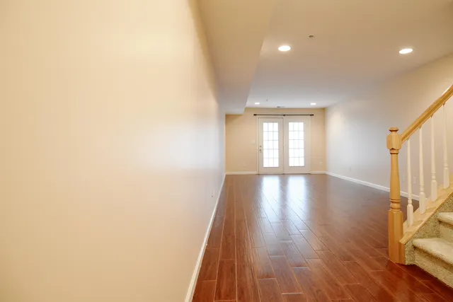 a view of a room with wooden floor and window