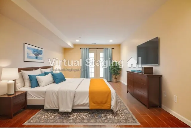 a bedroom with a bed a couch and dresser