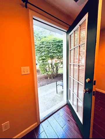 a view of a room with wooden floor and a window