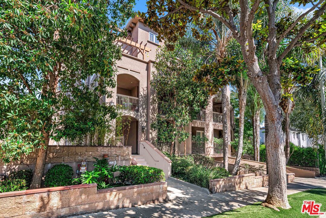 1248 North Laurel Avenue, Unit 103 West Hollywood, CA 90046 - Photo 1 of 25 a front view of a house with garden