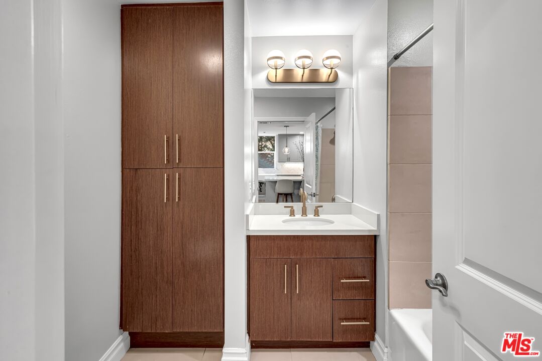 1248 North Laurel Avenue, Unit 103 West Hollywood, CA 90046 - Photo 14 of 25 a bathroom with a sink a toilet and mirror