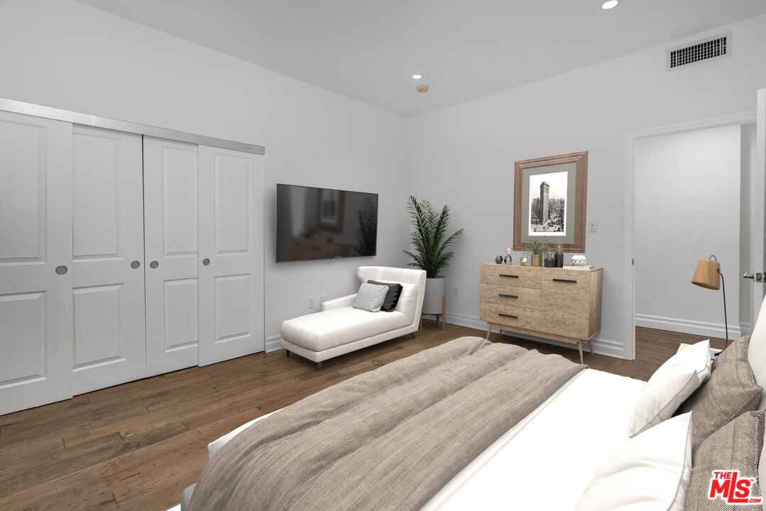 1248 North Laurel Avenue, Unit 103 West Hollywood, CA 90046 - Photo 17 of 25 a bedroom with a bed and a flat screen tv