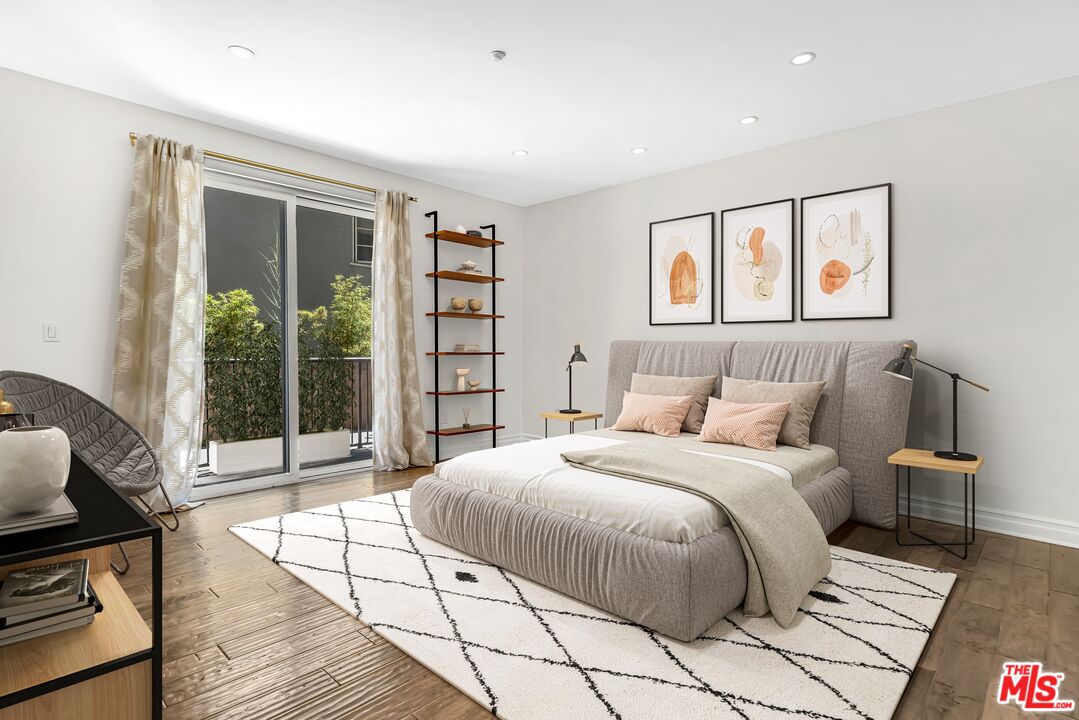 1248 North Laurel Avenue, Unit 103 West Hollywood, CA 90046 - Photo 3 of 25 a bedroom with a large bed and a window