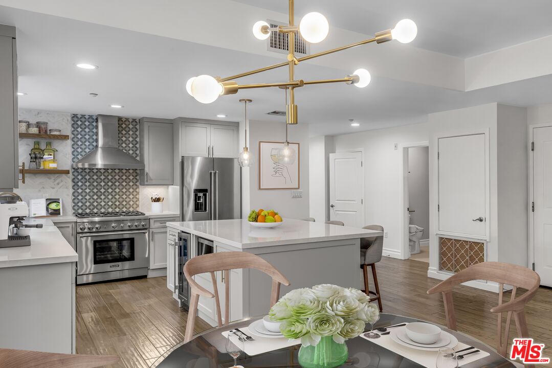 1248 North Laurel Avenue, Unit 103 West Hollywood, CA 90046 - Photo 6 of 25 a living room with stainless steel appliances kitchen island granite countertop furniture and a fireplace