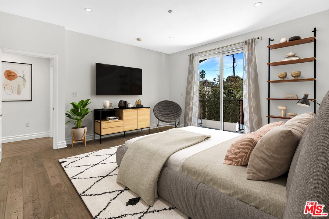 1248 North Laurel Avenue, Unit 103 West Hollywood, CA 90046 - Photo 8 of 25 a bedroom with a bed and a flat screen tv