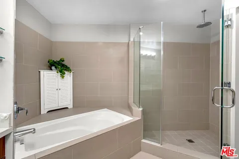 a bathroom with a bathtub and a shower