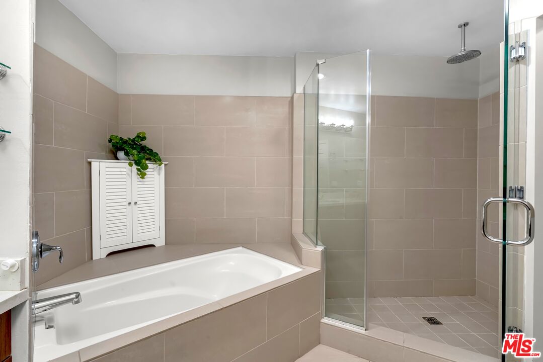 1248 North Laurel Avenue, Unit 103 West Hollywood, CA 90046 - Photo 10 of 25 a bathroom with a bathtub and a shower