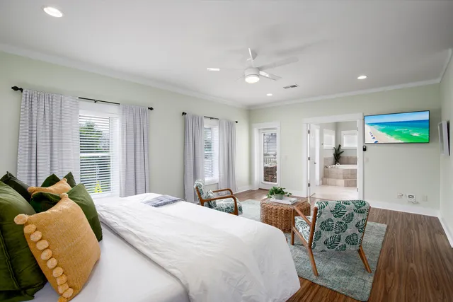 a spacious bedroom with a bed a couch and dresser