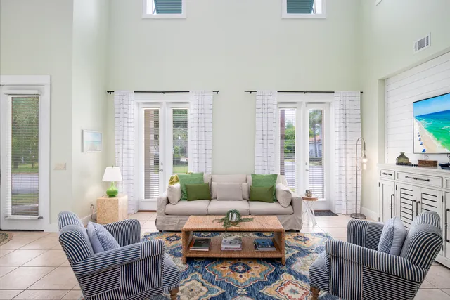 a living room with furniture fireplace and a large window