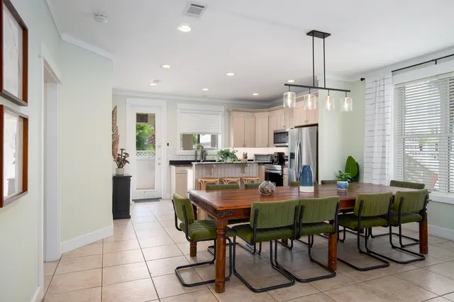 a view of a dining room and livingroom with furniture wooden floor a chandelier