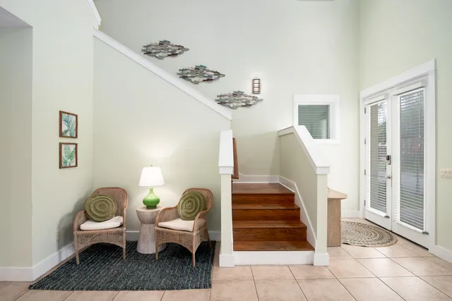 a living room with furniture and stairs