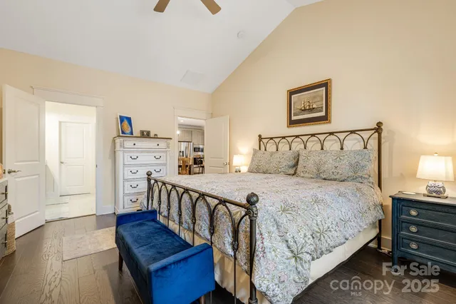 a bedroom with bed and wooden floor