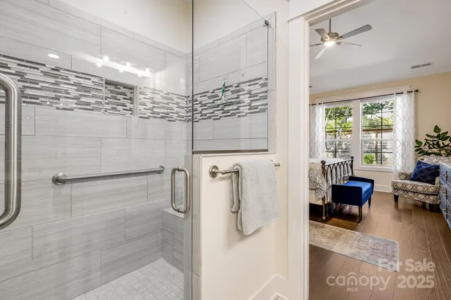 a bathroom with a shower and a table