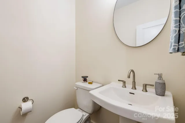 a bathroom with a sink mirror and toilet
