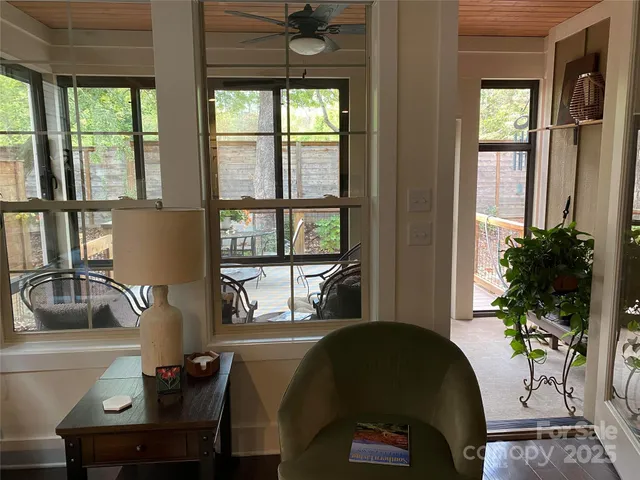 a living room with furniture and a potted plant