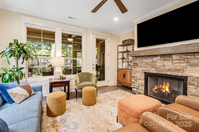 a living room with furniture fireplace and flat screen tv
