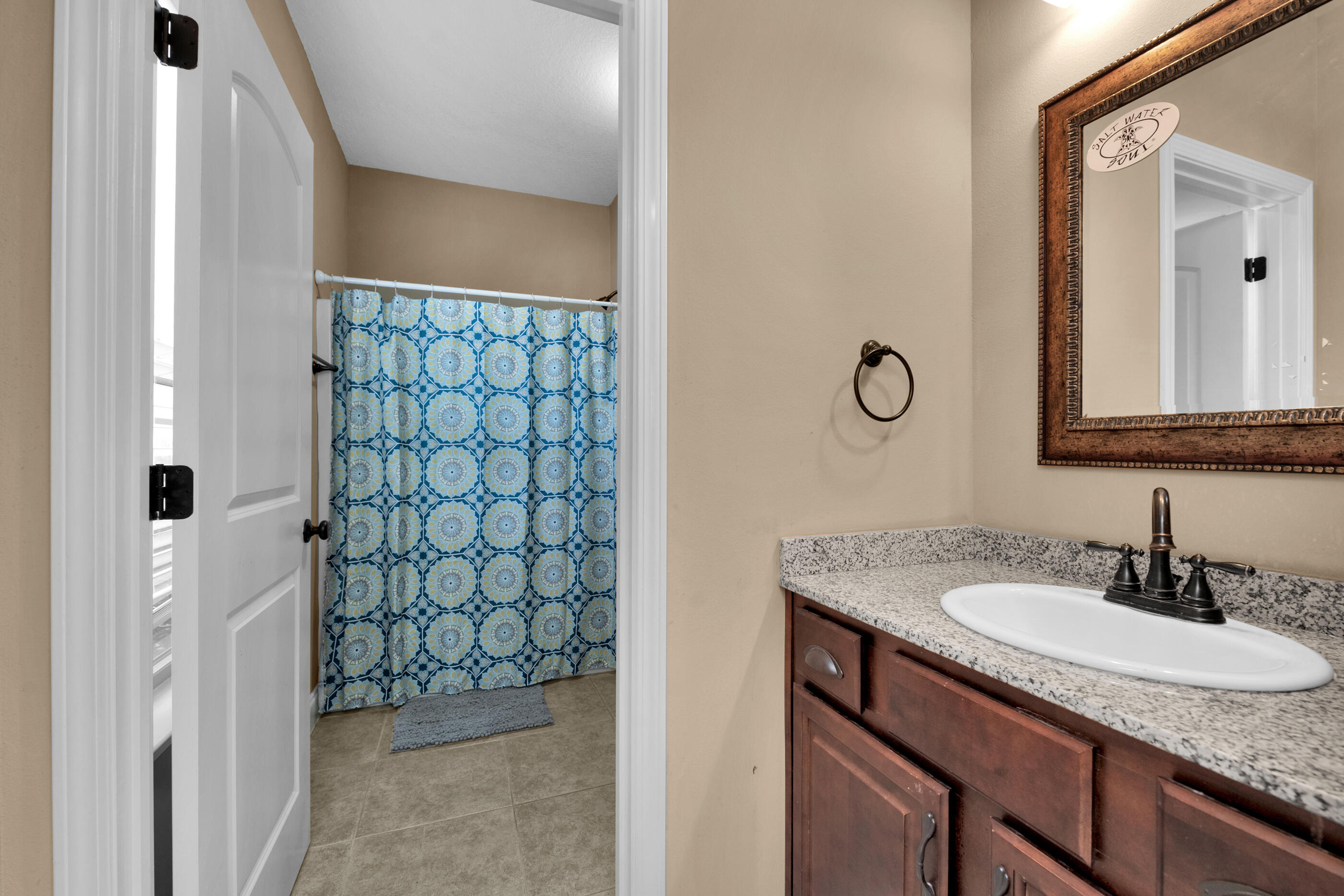 4632 Hermosa Road Crestview, FL 32539 - Photo 13 of 22 a bathroom with a granite countertop sink and a mirror