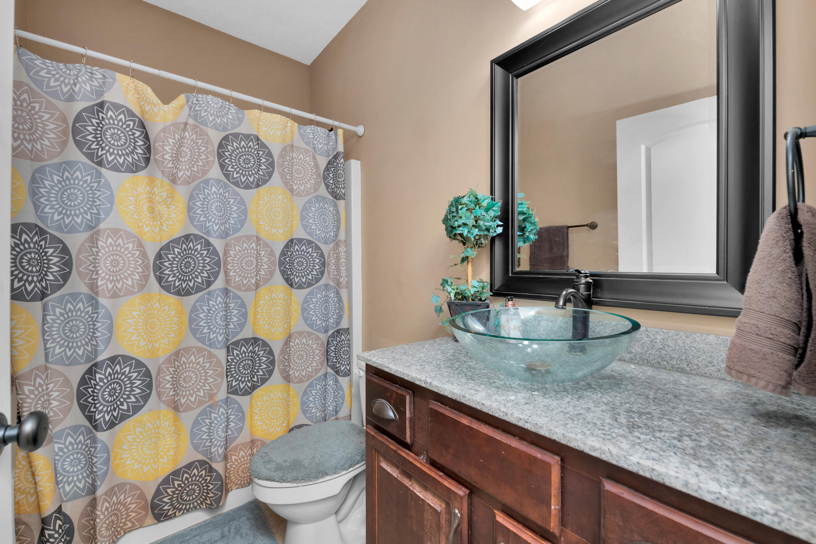 4632 Hermosa Road Crestview, FL 32539 - Photo 17 of 22 a bathroom with a granite countertop toilet sink and mirror
