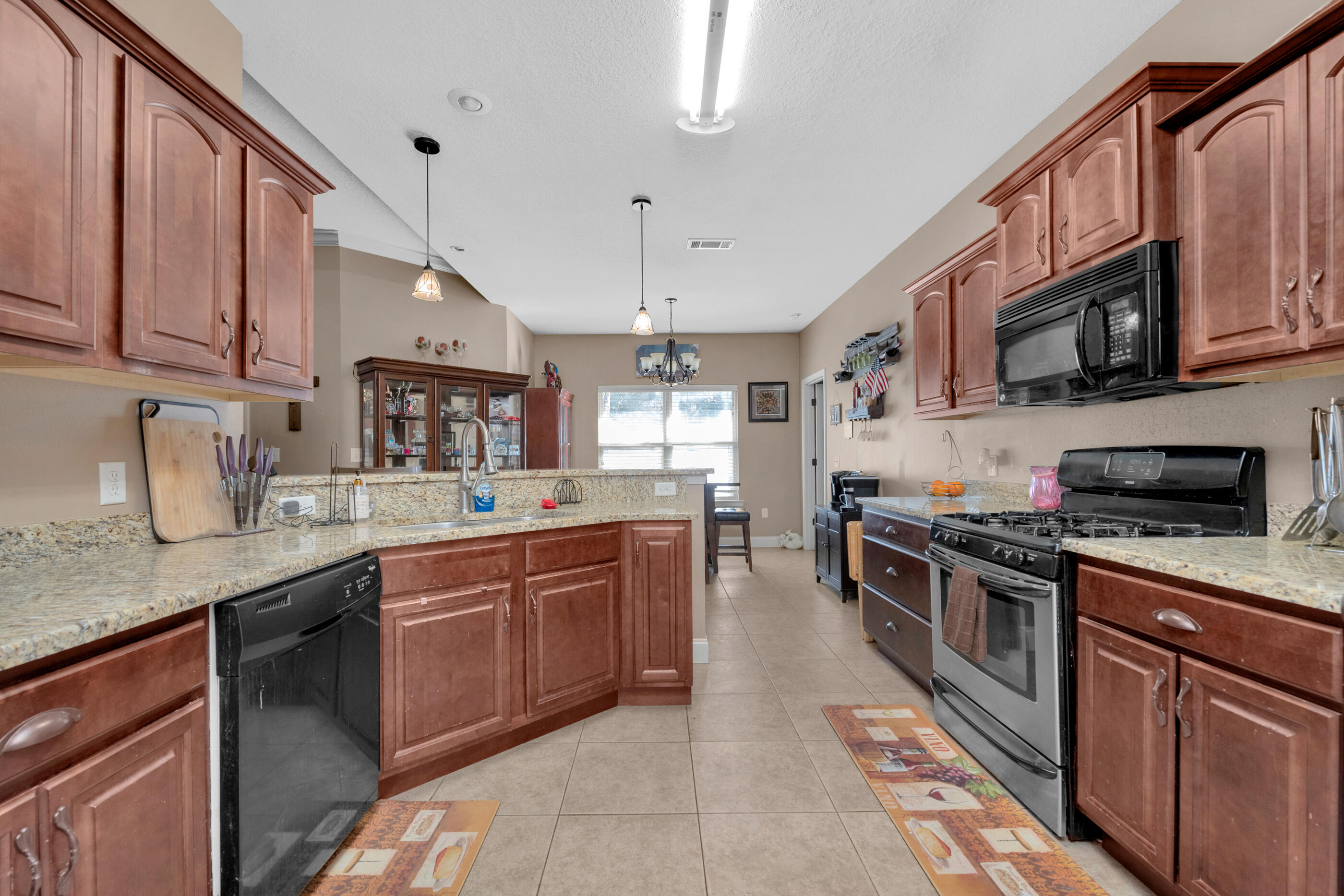4632 Hermosa Road Crestview, FL 32539 - Photo 6 of 22 a kitchen with stainless steel appliances granite countertop a sink a stove top oven a counter space and cabinets