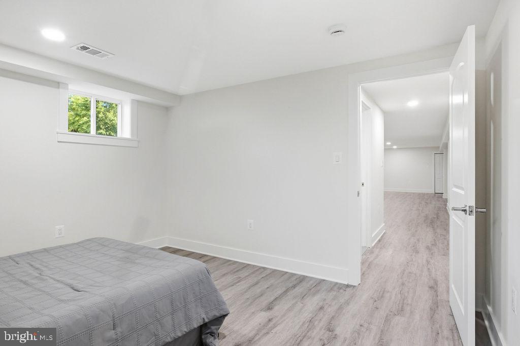 6620 Napoli Road Temple Hills, MD 20748 - Photo 32 of 38 an empty room with wooden floor and windows