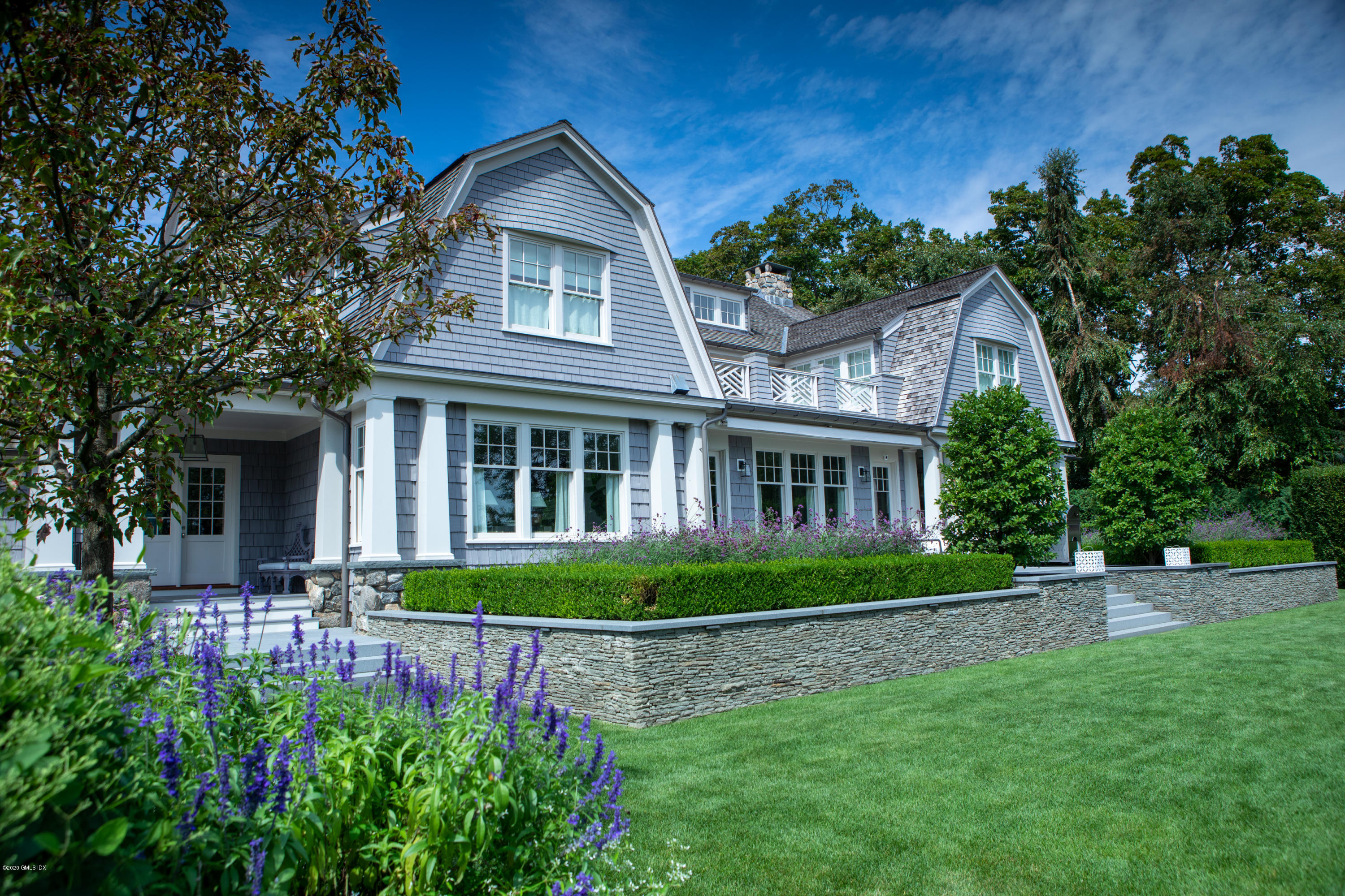 Undisclosed Address Greenwich, CT 06830 - Photo 29 of 30 a front view of a house with a garden