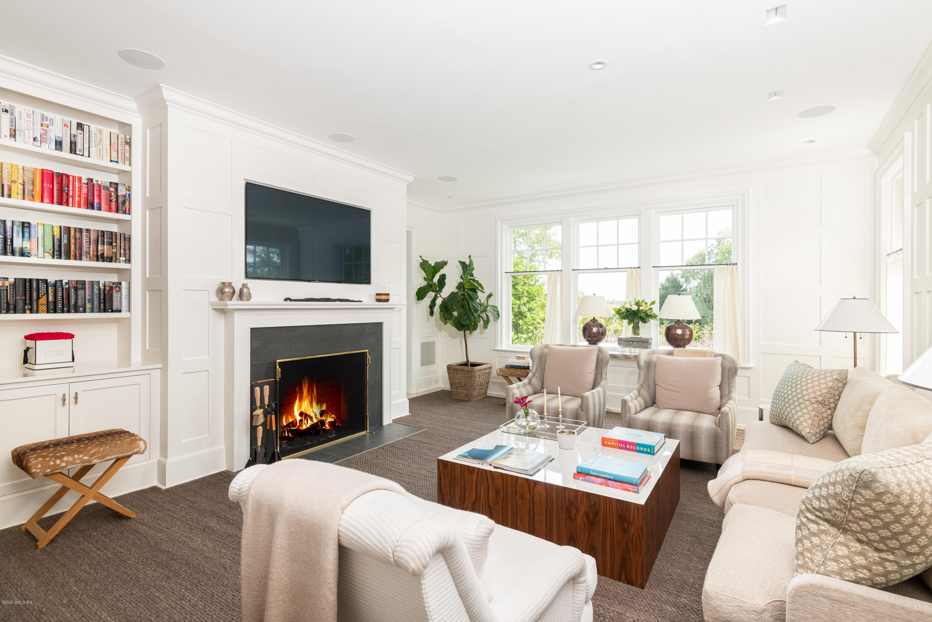 Undisclosed Address Greenwich, CT 06830 - Photo 9 of 30 a living room with furniture a flat screen tv and a fireplace