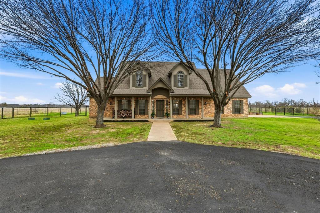 492 Thomas J Egan Road Denton, TX 76207 - Photo 1 of 1 View of front facade featuring a porch, brick siding, and roof with shingles