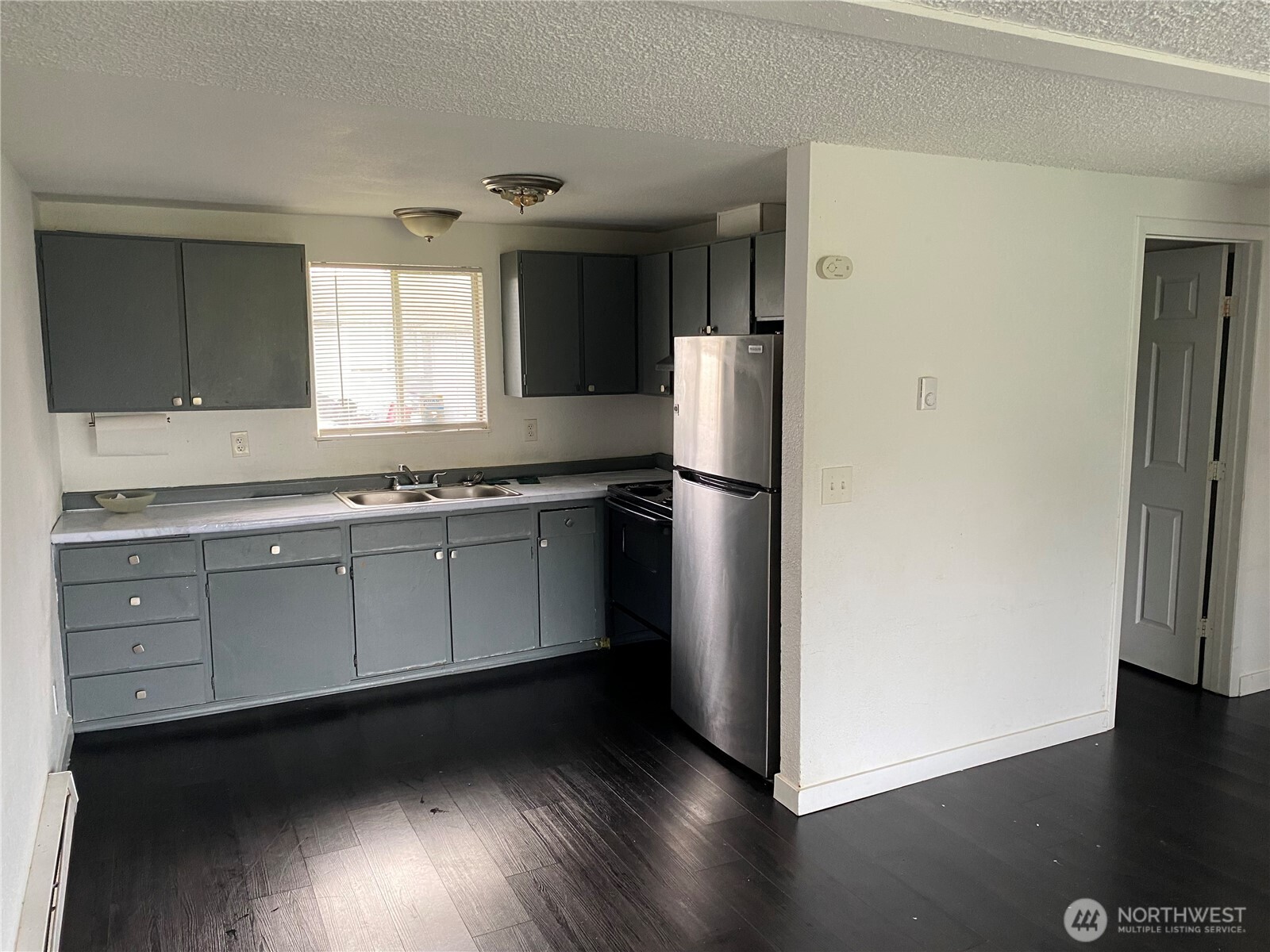 1123 Lindstrom Street Aberdeen, WA 98520 - Photo 2 of 8 a kitchen with a refrigerator and a stove top oven