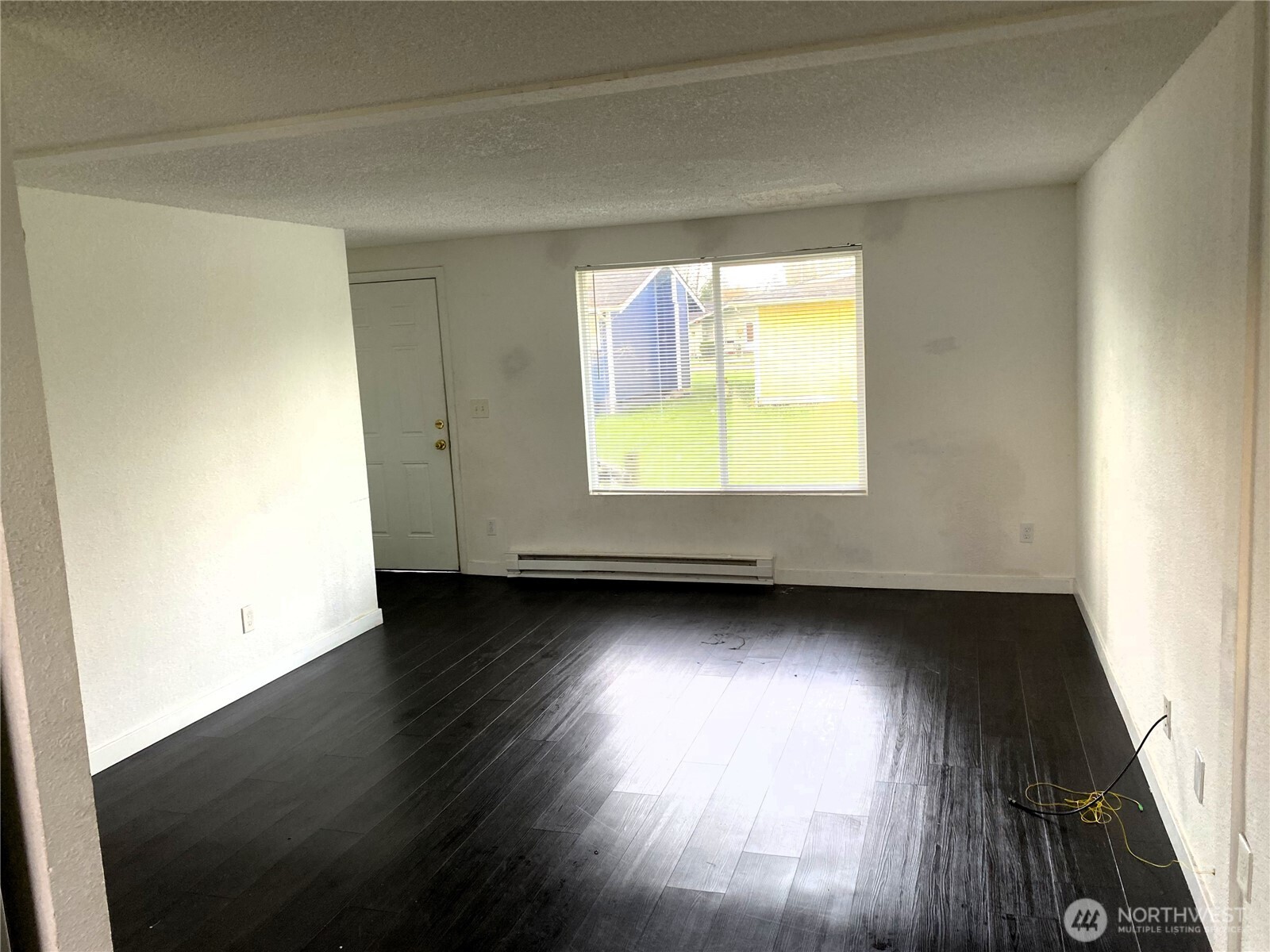 1123 Lindstrom Street Aberdeen, WA 98520 - Photo 3 of 8 an empty room with wooden floor and windows