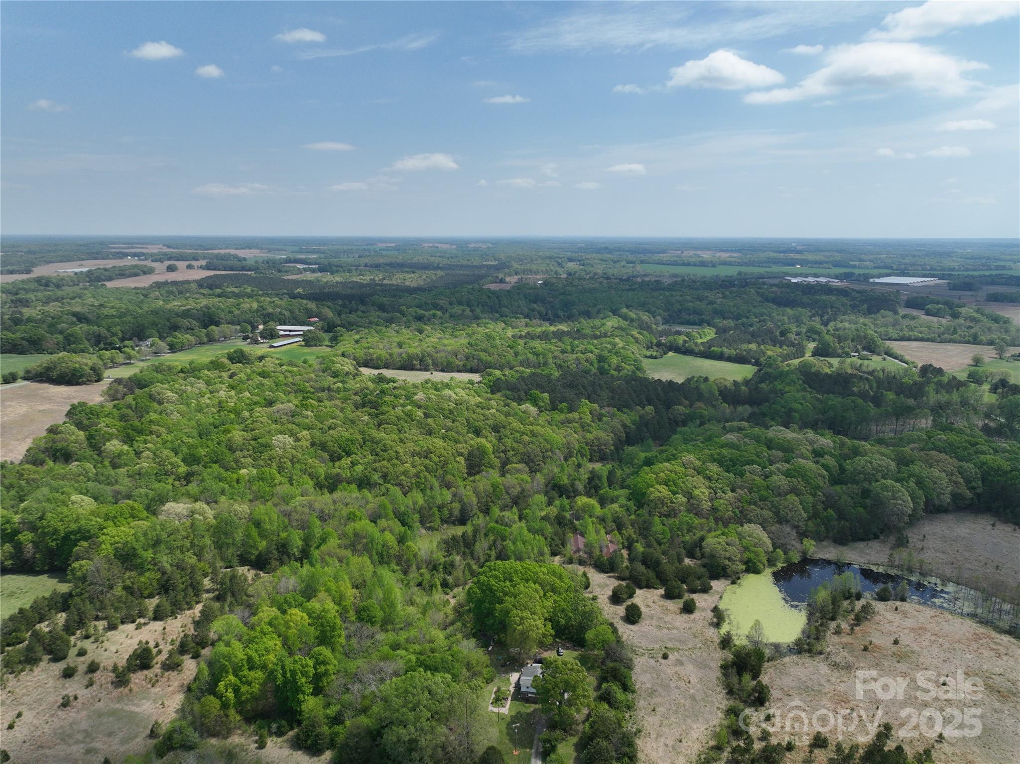 1720 Trinity Church Road Monroe, NC 28112 - Photo 3 of 8 a view of a field of grass and trees