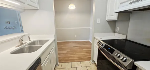 a kitchen with a sink stove and cabinets