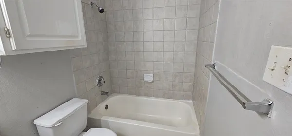 a bathroom with a bathtub and toilet