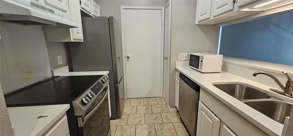 a kitchen with a sink and a refrigerator