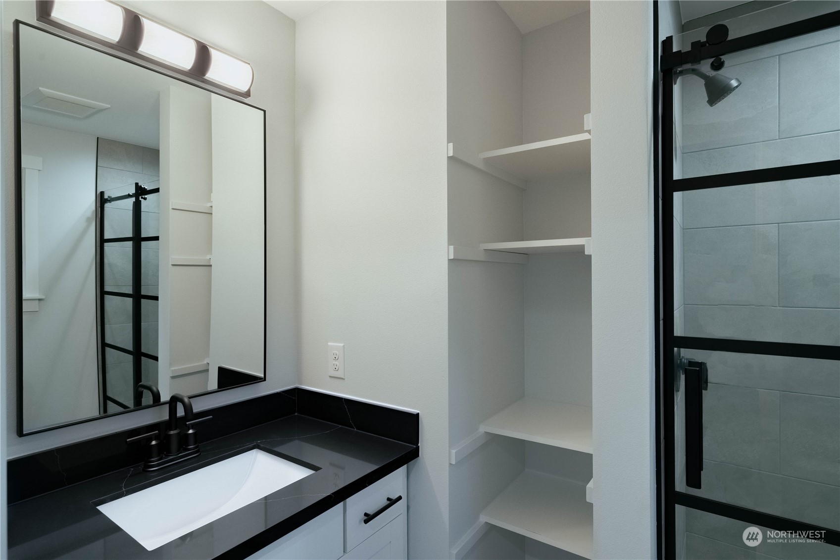 1654 Baby Doll Road Southeast Port Orchard, WA 98366 - Photo 14 of 30 a bathroom with a sink a mirror and shower