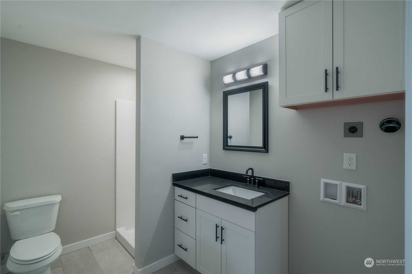1654 Baby Doll Road Southeast Port Orchard, WA 98366 - Photo 18 of 30 a bathroom with a granite countertop sink a toilet and a mirror