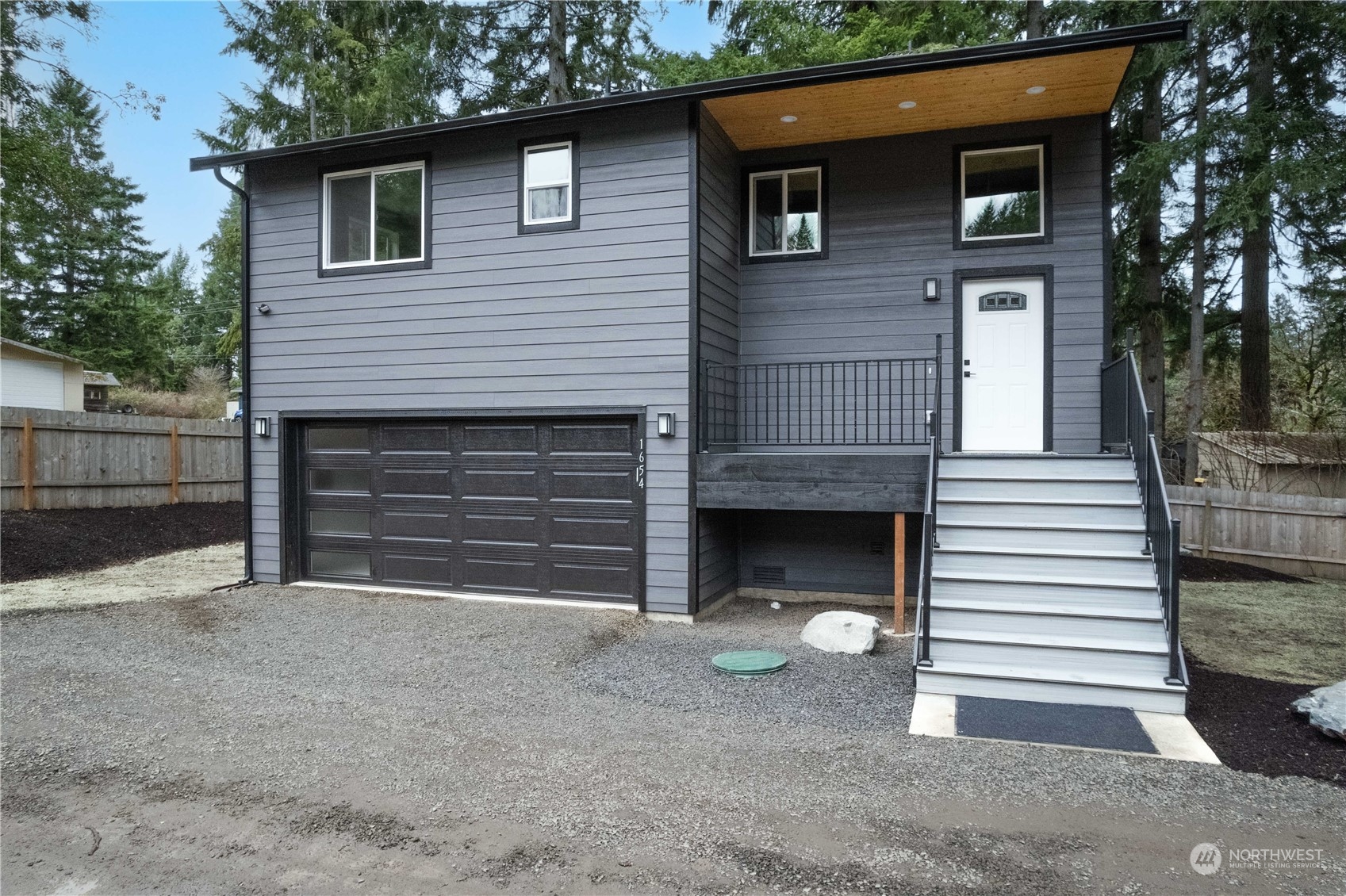1654 Baby Doll Road Southeast Port Orchard, WA 98366 - Photo 29 of 30 a front view of a house with a yard and garage