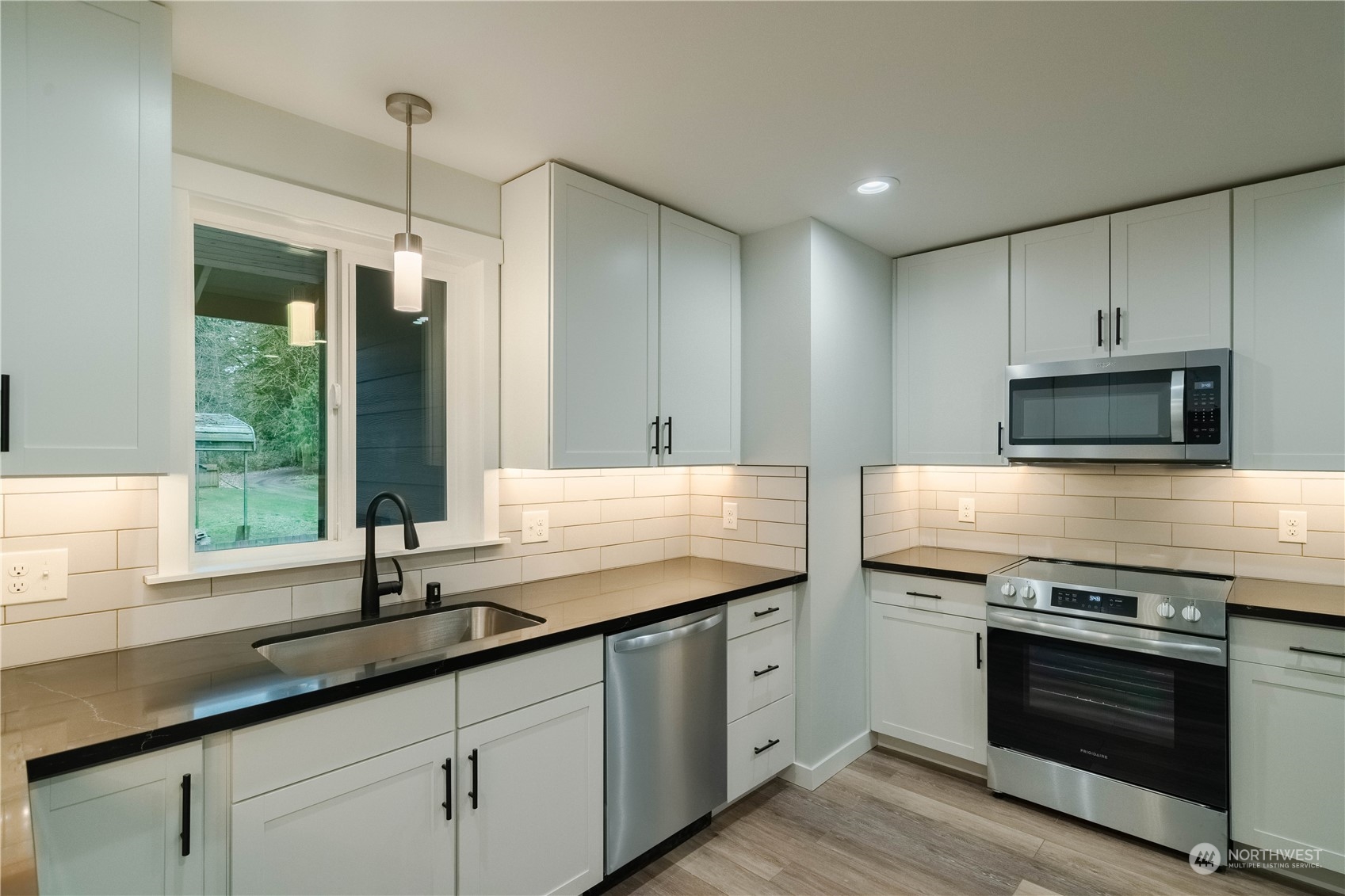 1654 Baby Doll Road Southeast Port Orchard, WA 98366 - Photo 3 of 30 a kitchen with a sink stove and microwave