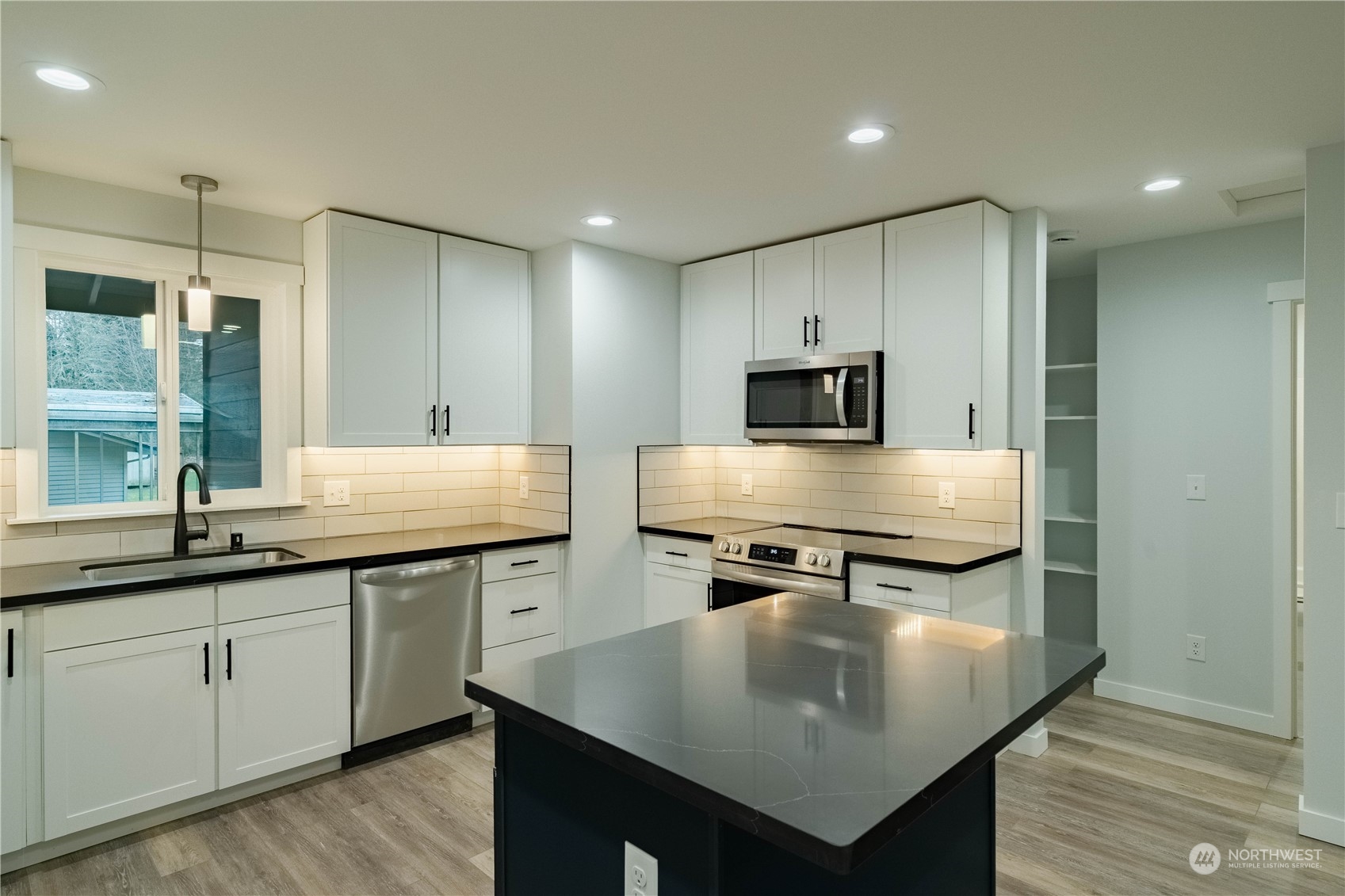 1654 Baby Doll Road Southeast Port Orchard, WA 98366 - Photo 4 of 30 a kitchen with a stove a sink and a refrigerator