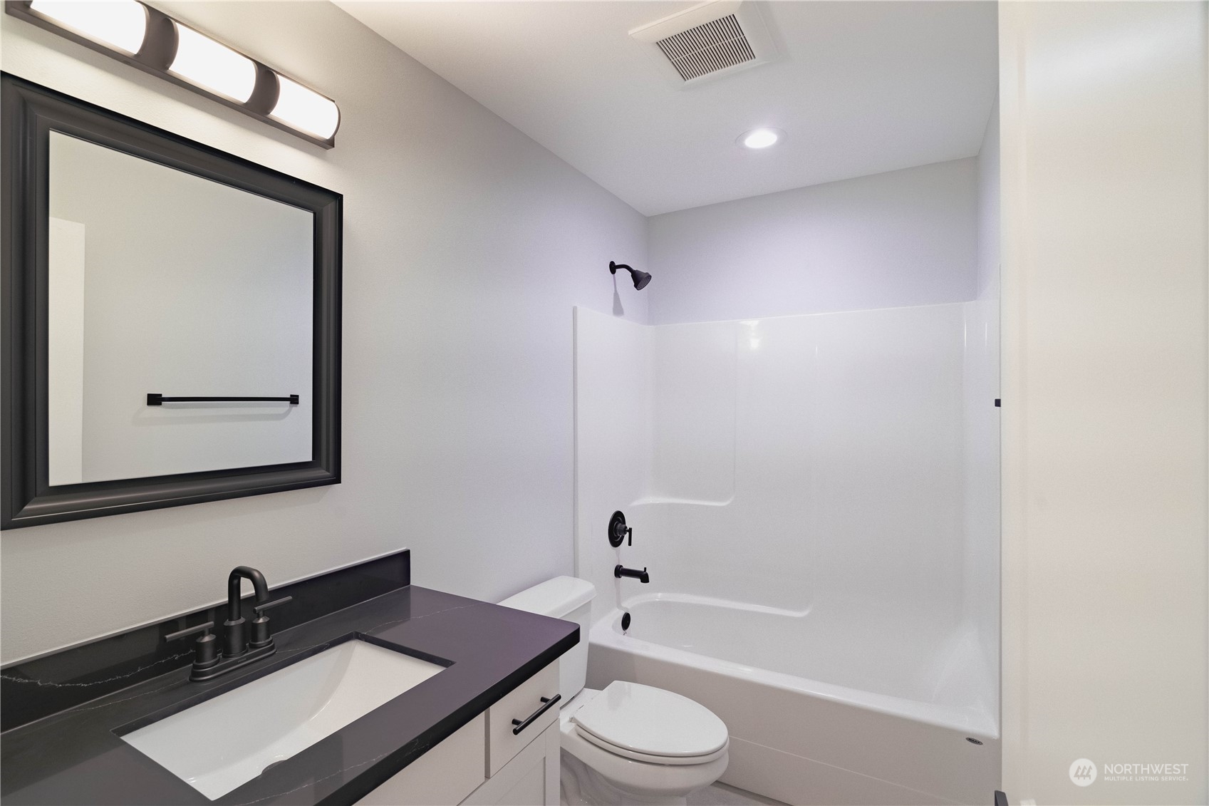 1654 Baby Doll Road Southeast Port Orchard, WA 98366 - Photo 8 of 30 a bathroom with a toilet a sink a mirror a bathtub and vanity