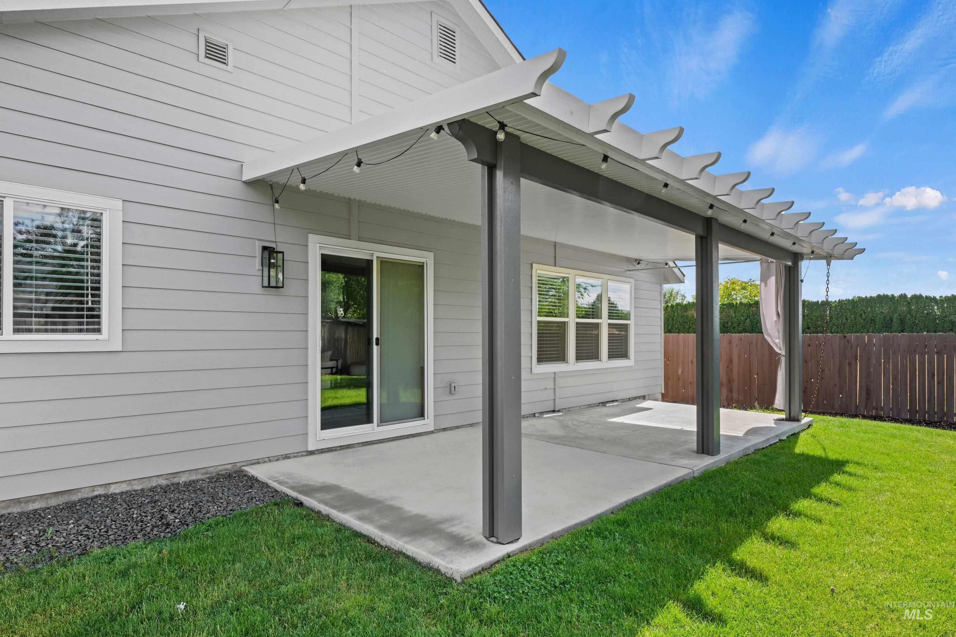 12744 West Fig Street Boise, ID 83713 - Photo 32 of 34 Covered patio with string lighting, pergola detailing, and concrete flooring