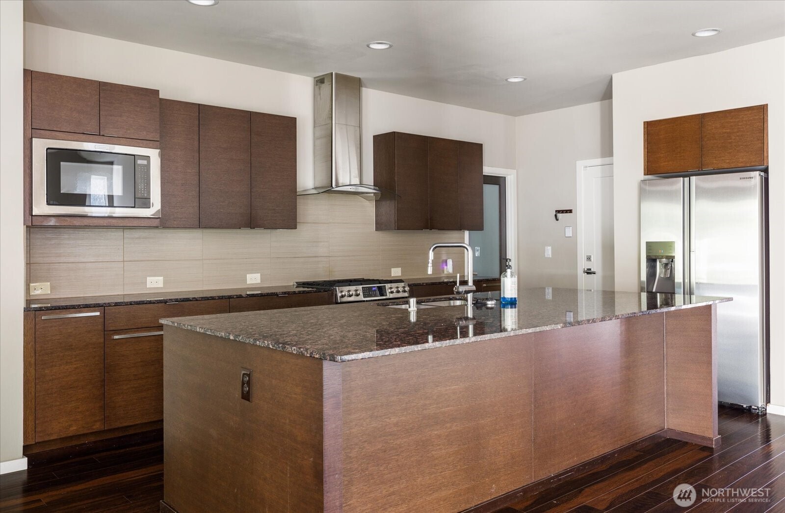 3701 170th Place Southeast Bothell, WA 98012 - Photo 11 of 37 a kitchen with kitchen island granite countertop a sink and a stove top oven