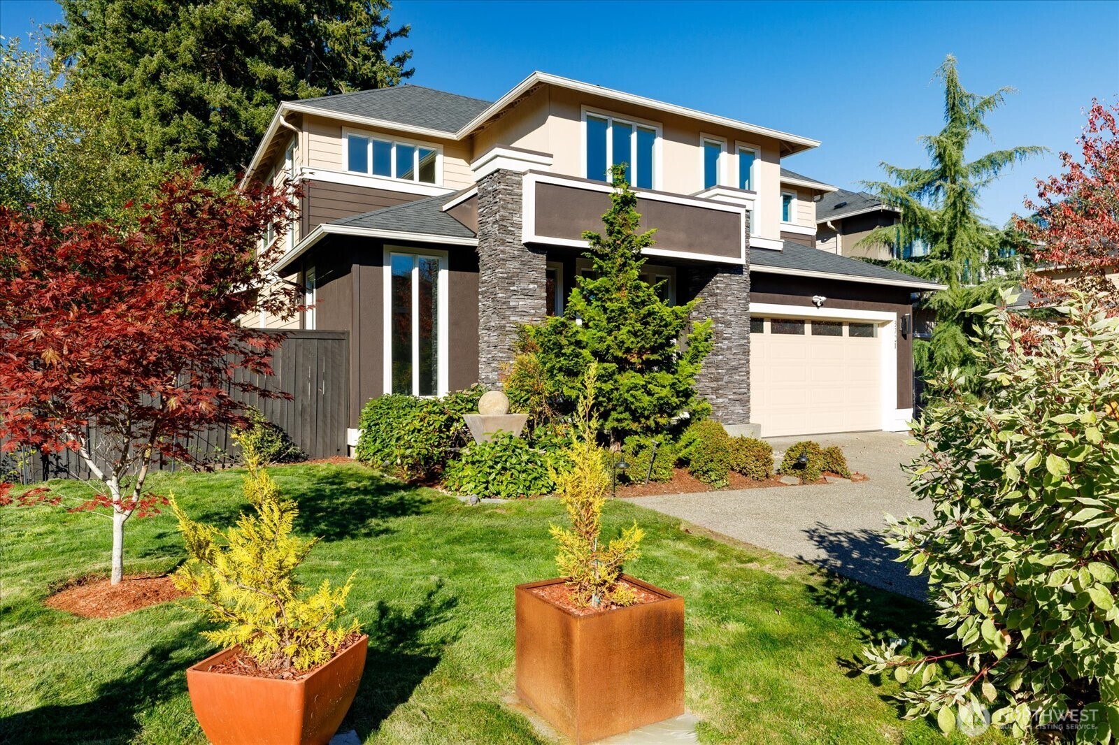3701 170th Place Southeast Bothell, WA 98012 - Photo 2 of 37 a front view of a house with a yard and garage