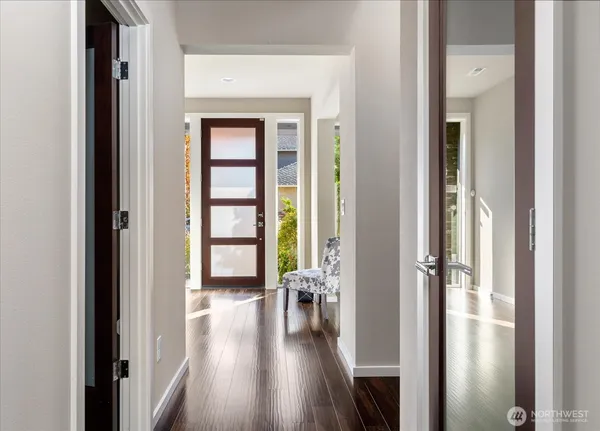 a view of a hallway with wooden floor windows and livingroom