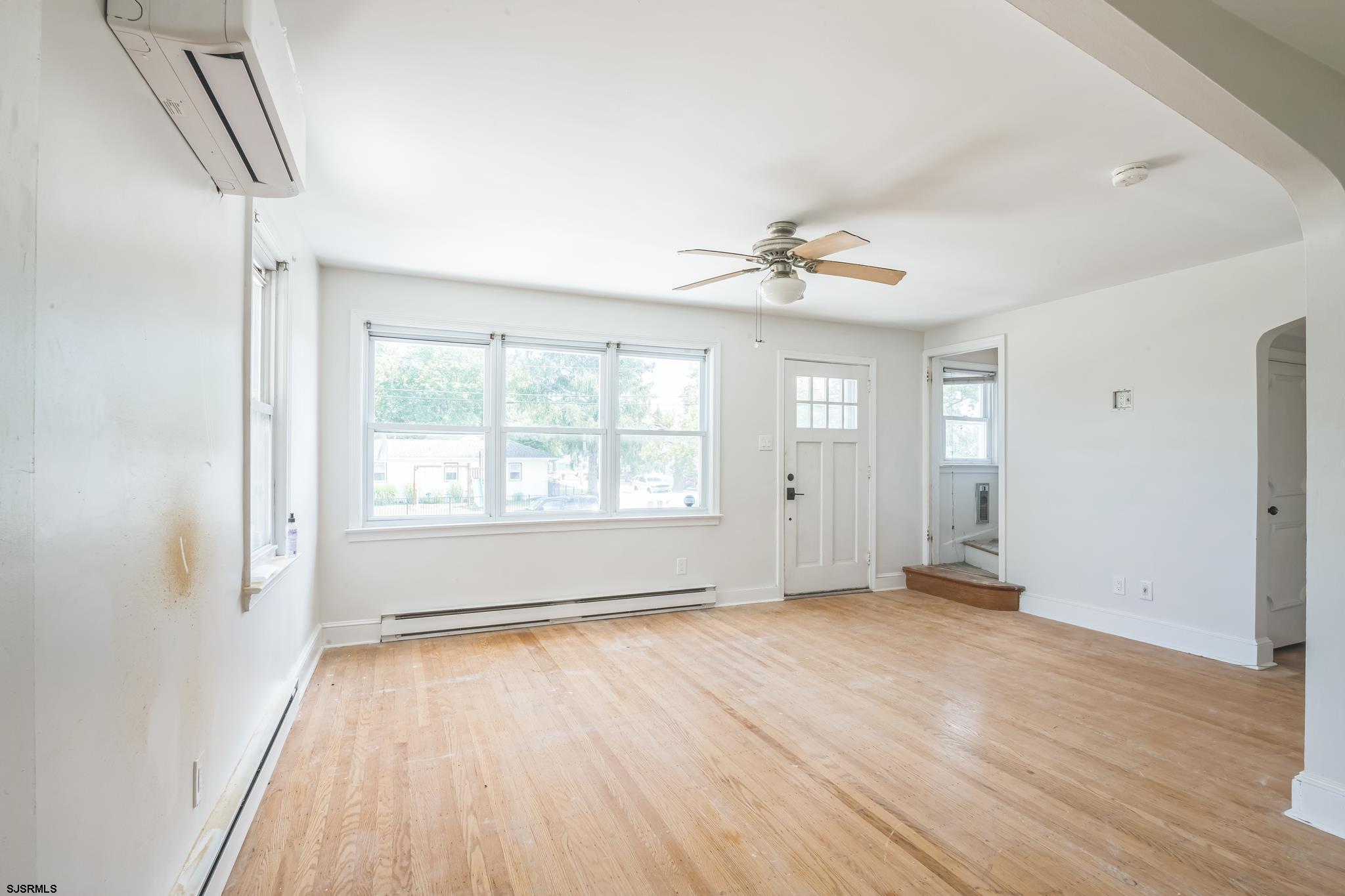 29 East Pierson Avenue Somers Point, NJ 08244 - Photo 3 of 15 a view of an empty room with a window and wooden floor