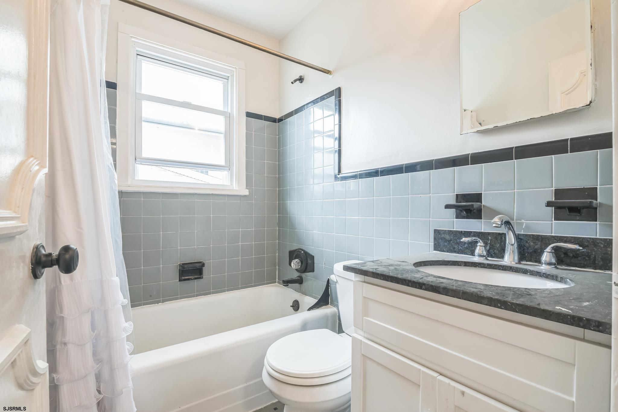 29 East Pierson Avenue Somers Point, NJ 08244 - Photo 8 of 15 a bathroom with a granite countertop sink a toilet and bathtub