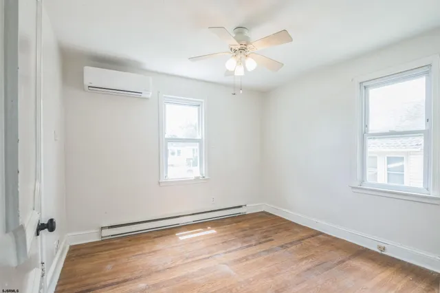 wooden floor in an empty room with a window