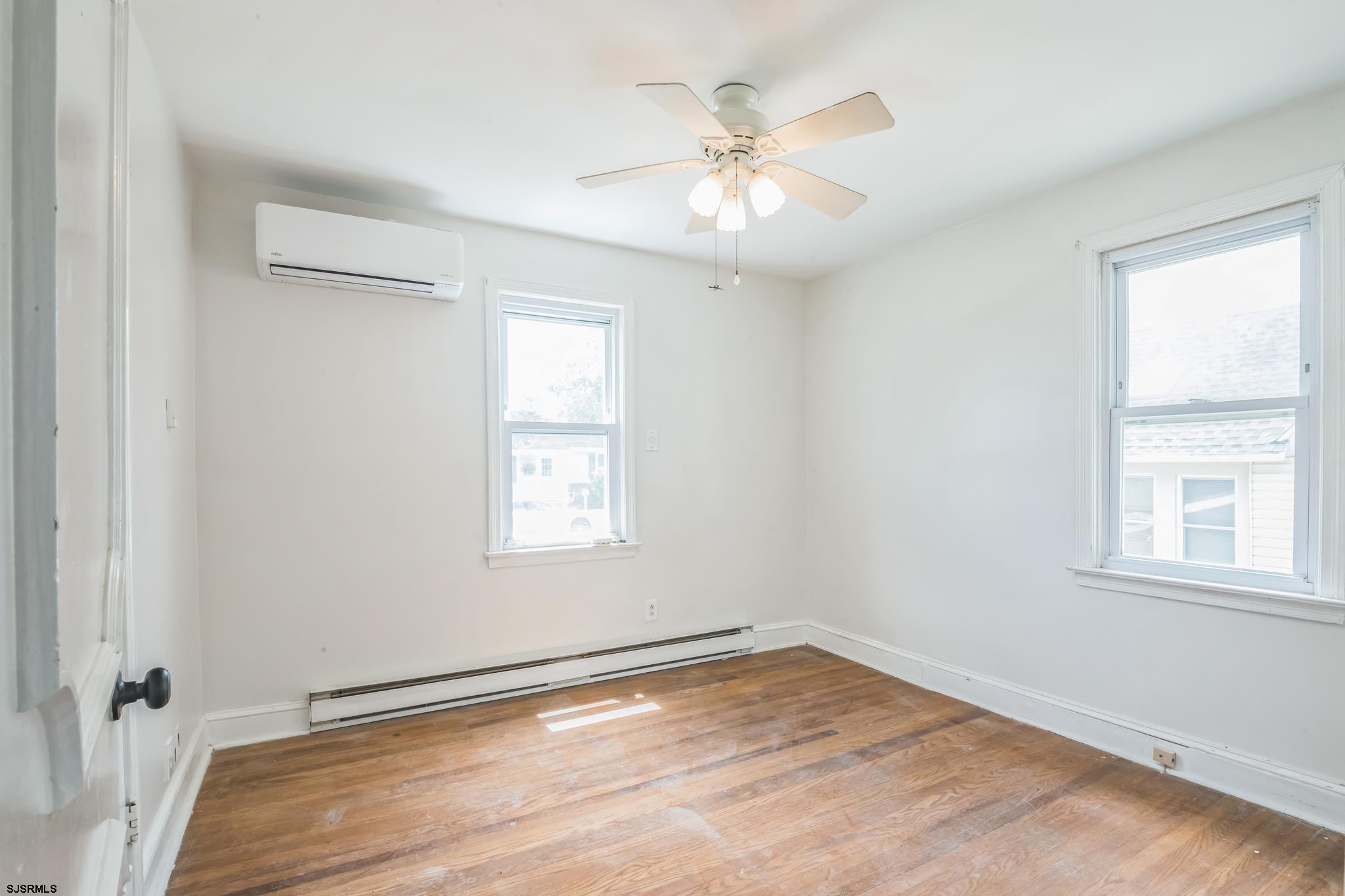 29 East Pierson Avenue Somers Point, NJ 08244 - Photo 9 of 15 wooden floor in an empty room with a window
