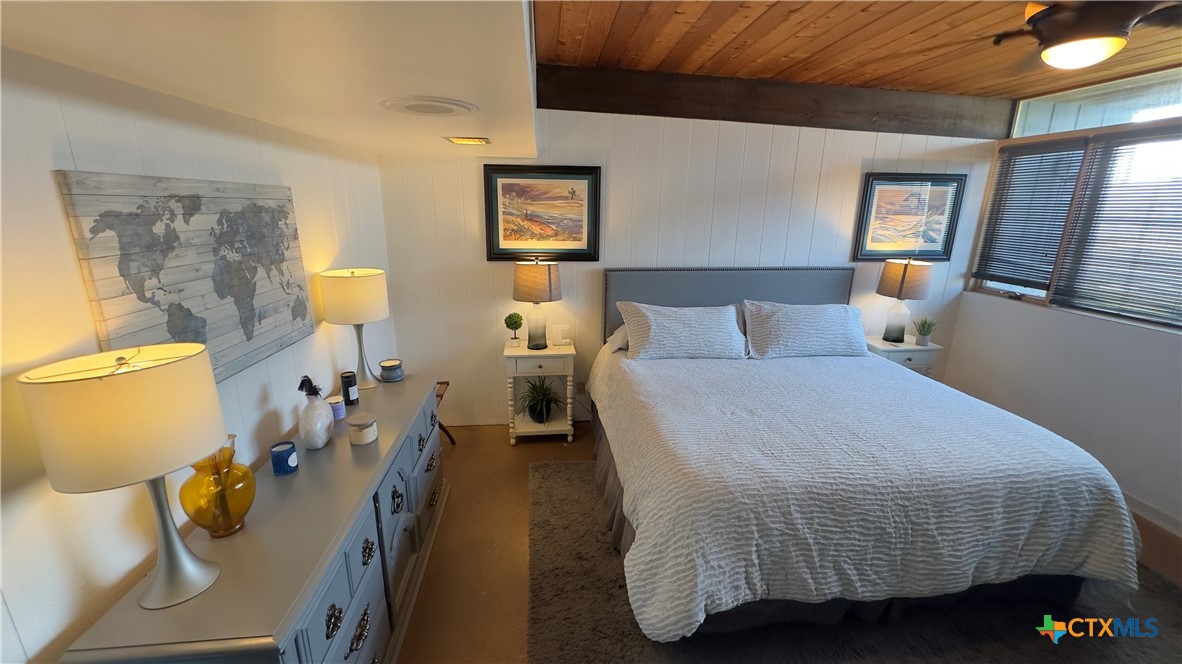 601 Lawrence Street Refugio, TX 78377 - Photo 14 of 42 a bedroom with a bed and wooden floor